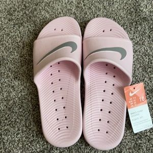 Pink and grey Nike slides